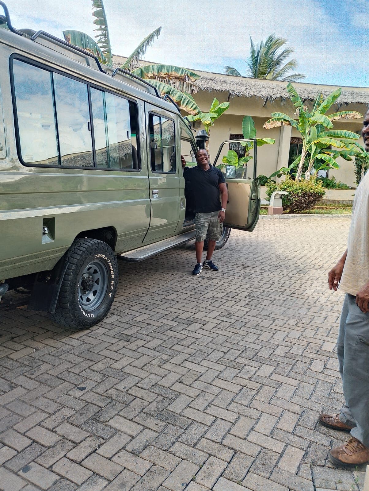 Alfonze Kazungu with a colleague beside his branded safari vehicle